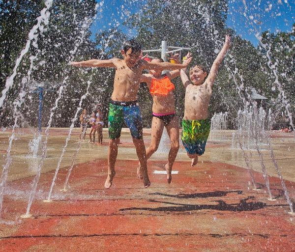 Kids playing in the splash pad at Palmetto Island State Park